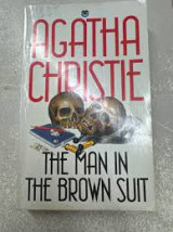 The man in the brown suit